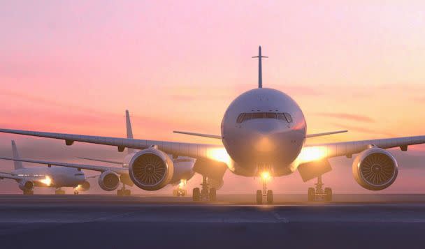 PHOTO: Airplanes are shown taxiing on runway at sunset in this stock photo. (STOCK PHOTO/Getty Images)