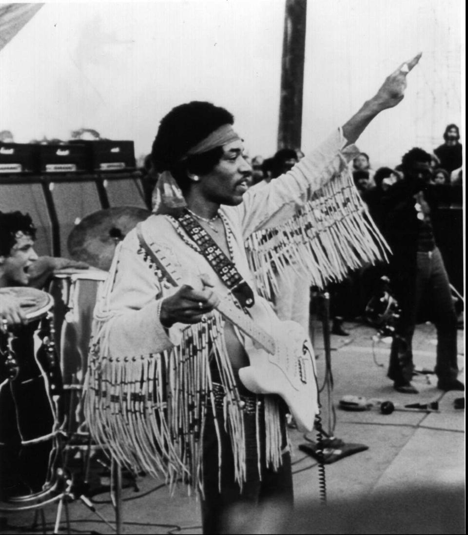 Jimi Hendrix played to an estimated audience of 200,000 people at the end of the inaugural Woodstock music festival in 1969.