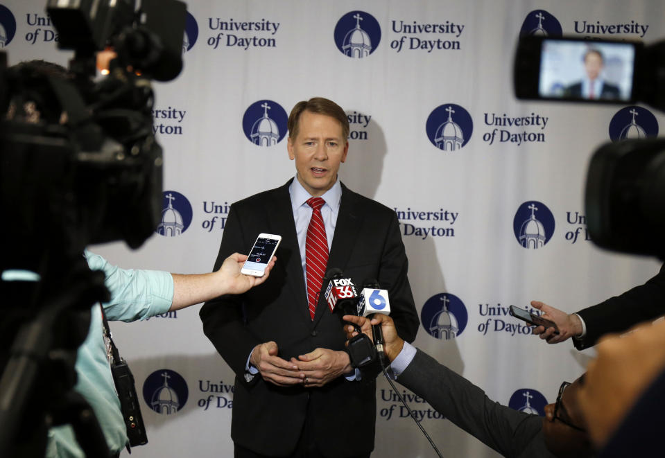 Ohio Democratic gubernatorial candidate Richard Cordray, center, speaks with the media in the spin room following a debate against Ohio Attorney General and Republican gubernatorial candidate Mike DeWine at the University of Dayton Wednesday, Sept. 19, 2018, in Dayton, Ohio. (AP Photo/Gary Landers)