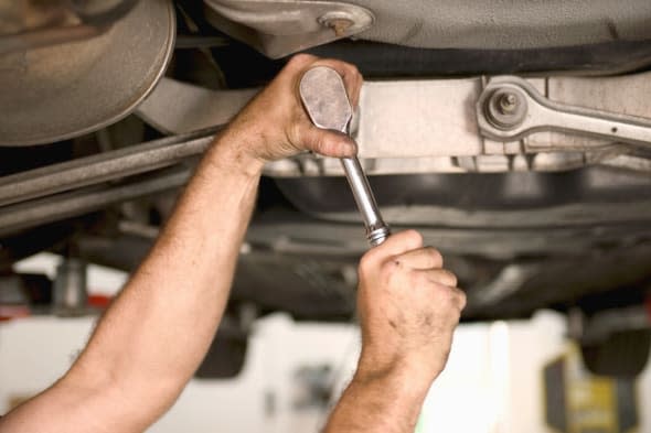 Title:   Mechanic working on car undercarriage, close-up Creative image #:  200157278-001 License type:  Royalty-free Photograph