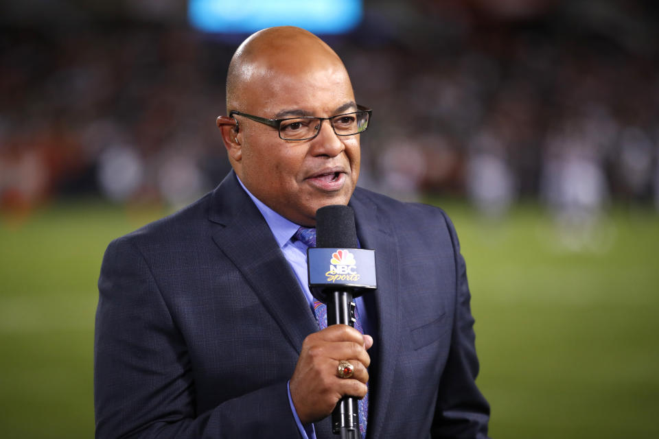 FILE - In this Sept. 5, 2019, file photo, NBC sportscaster Mike Tirico works the sidelines during an NFL football game between the Green Bay Packers and the Chicago Bears in Chicago. Tirico is one of many announcers who has had to trade the press box for a home office. (AP Photo/Jeff Haynes, File)