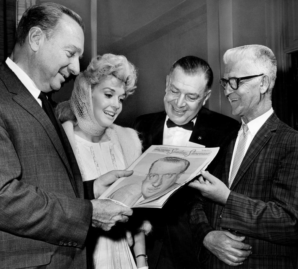 Dignitaries attending the Middle Tennessee News Photographers short course admire a colorful picture of Walter Cronkite on the front of The Tennessean’s Sunday Showcase on Oct. 12, 1963. They are Cronkite, left, of CBS-TV news; actress Donna Douglas, Elly Mae of the Beverly Hillbillies show; J. Winton Lemen, manager of the press-photo division of Eastman Kodak Co., and Cliff Edom of the University of Missouri School of Journalism.