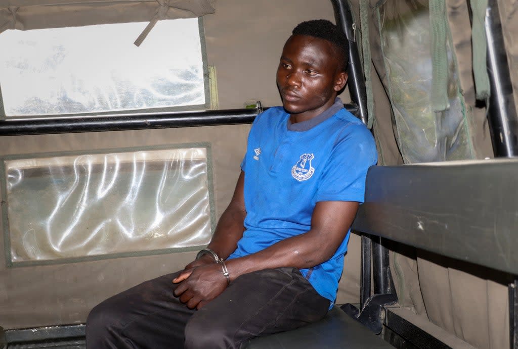 Masten Wanjala sat in the back of a police truck being taken by police to identify the location of alleged victim remains. (AP)