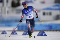 Johannes Hoesflot Klaebo, of Norway, crosses the finish line during the men's 15km classic cross-country skiing competition at the 2022 Winter Olympics, Friday, Feb. 11, 2022, in Zhangjiakou, China. (AP Photo/Alessandra Tarantino)