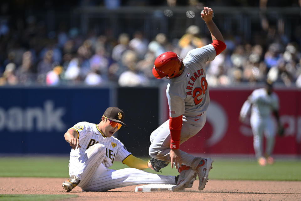 St. Louis Cardinals' Nolan Arenado (28) is tagged out at second base by San Diego Padres shortstop Ha-Seong Kim (7) as he tries to steal during the fourth inning of a baseball game, Wednesday, April 3, 2024, in San Diego. (AP Photo/Denis Poroy)