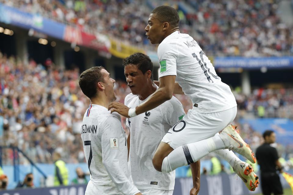 <p>France’s Kylian Mbappe, right, and Antoine Griezmann celebrate after Raphael Varane, centre scored his side’s first goal. </p>