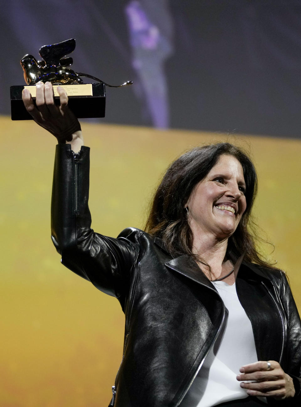 Director Laura Poitras holds the Golden Lion award for best film for 'All the Beauty and the Bloodshed' at the closing ceremony of the 79th edition of the Venice Film Festival in Venice, Italy, Saturday, Sept. 10, 2022. (AP Photo/Domenico Stinellis)