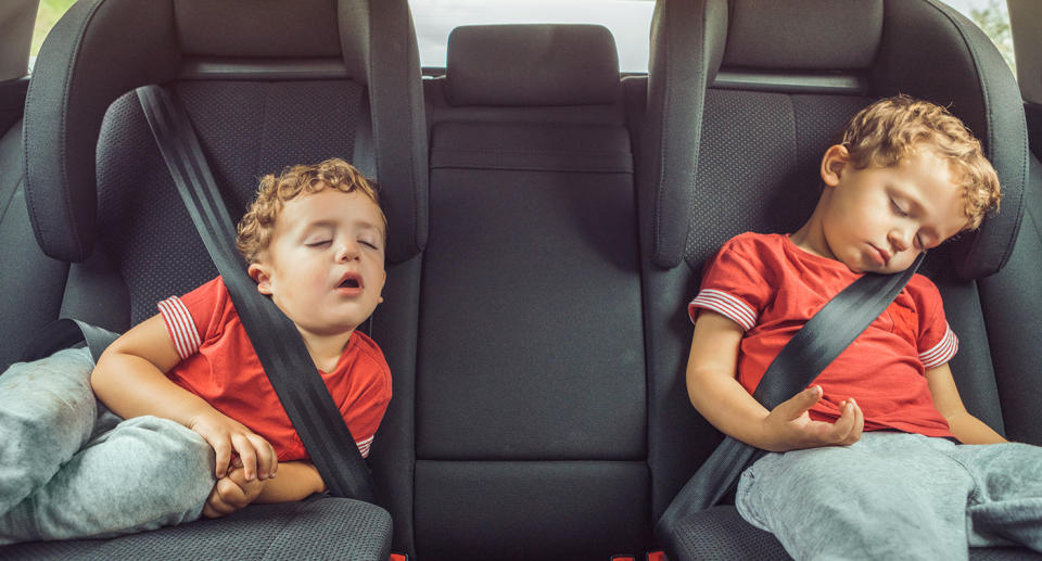 How much sleep do you need? children sleeping in the backseat of a car