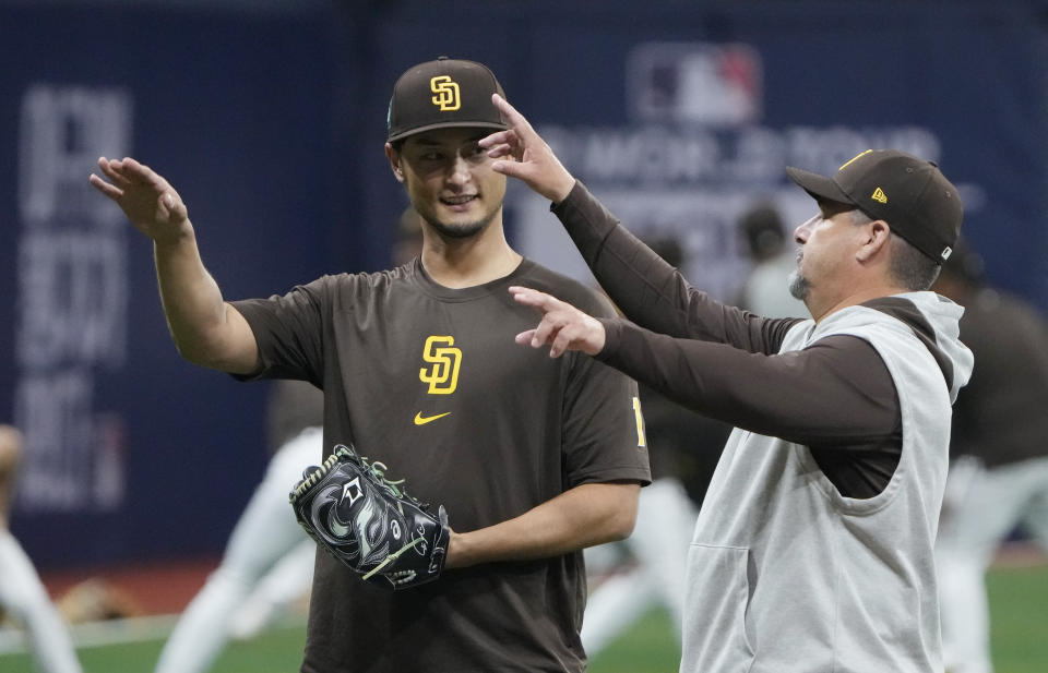 San Diego Padres' pitcher Yu Darvish, left, attends a baseball workout at the Gocheok Sky Dome in Seoul, South Korea, Tuesday, March 19, 2024. (AP Photo/Ahn Young-joon)