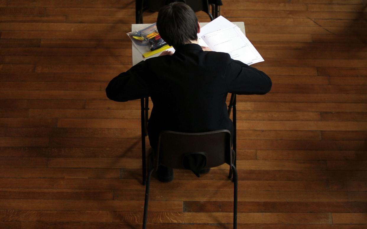 Pupil sitting in an exam hall - David Davies/PA