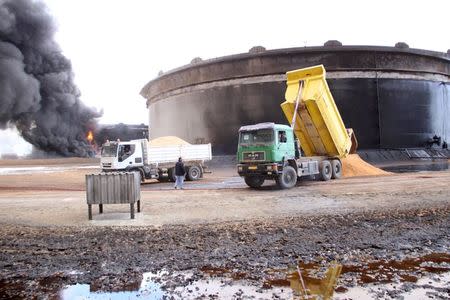 Smoke rises from burning oil storage tanks in the port of Ras Lanuf, Libya, January 23, 2016. REUTERS/Stringer