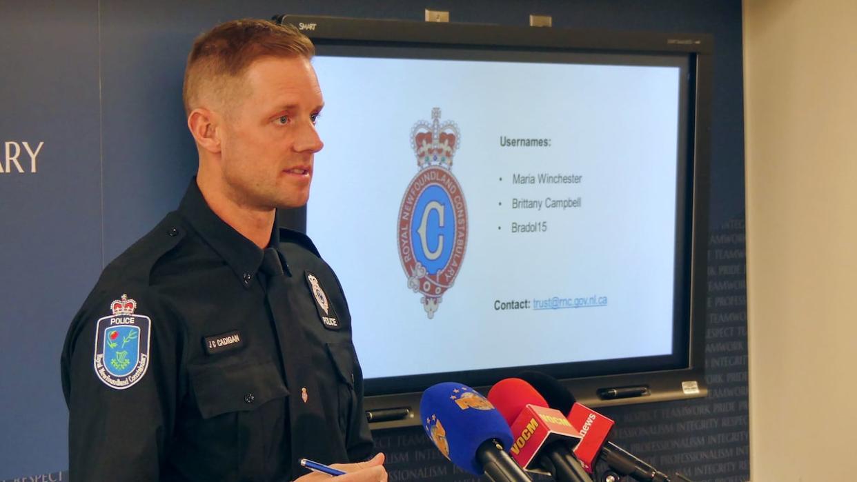 Const. James Cadigan of the Royal Newfoundland Constabulary provides an update on the investigation into 32-year-old teacher and coach Markus Hicks on Tuesday. (Ryan Cooke/CBC - image credit)