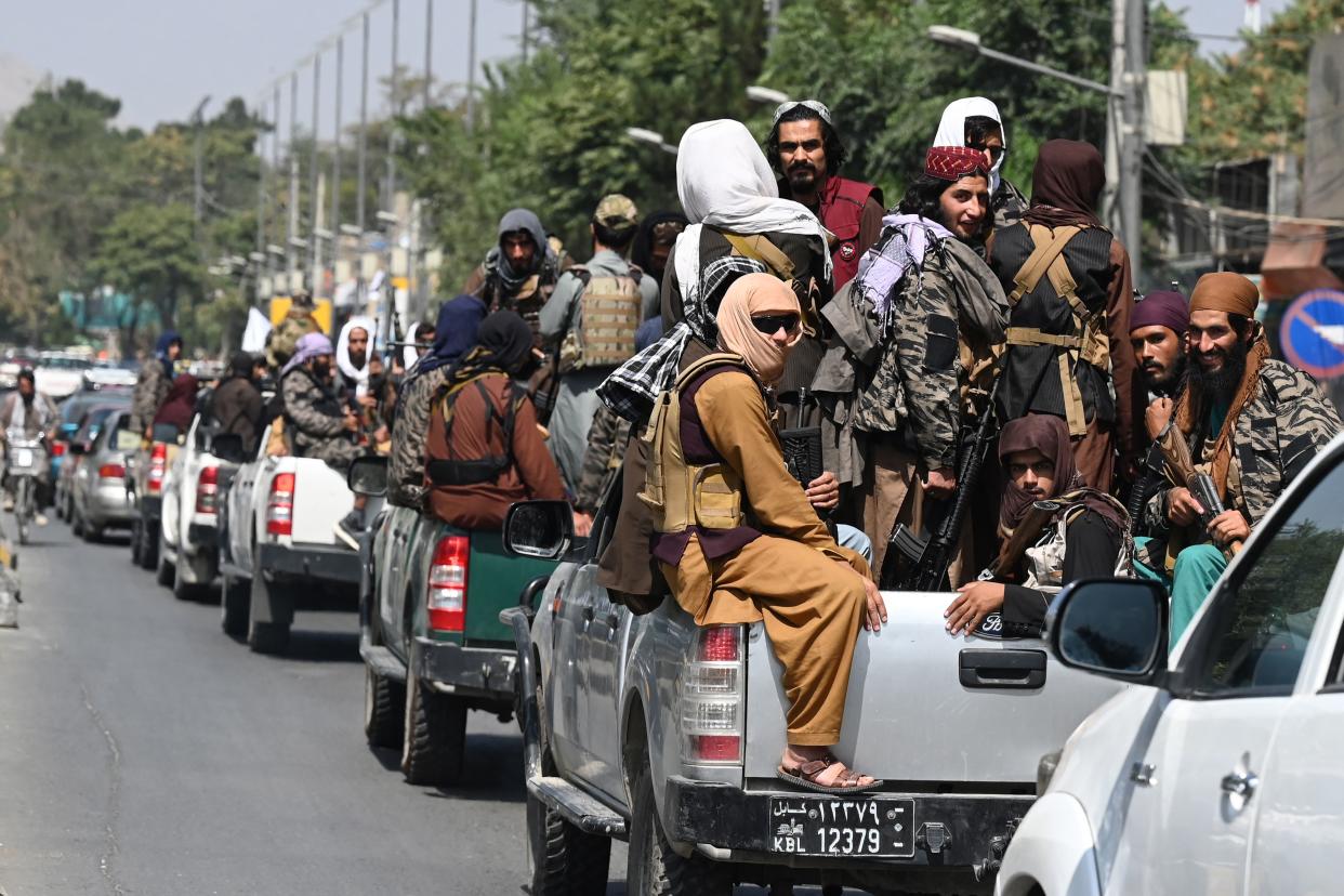 A convoy of Taliban fighters patrol along a street in Kabul on Thursday. (Aamir Qureshi/AFP via Getty Images)