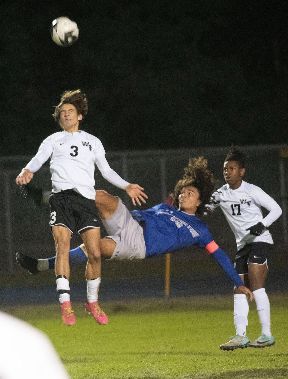 West Florida's Grey Griffin (No. 3) clears the ball out of the box as Washington's Kyle Hunnicutt (No. 10) tries for the bicycle kick during Tuesday's prep soccer matchup.