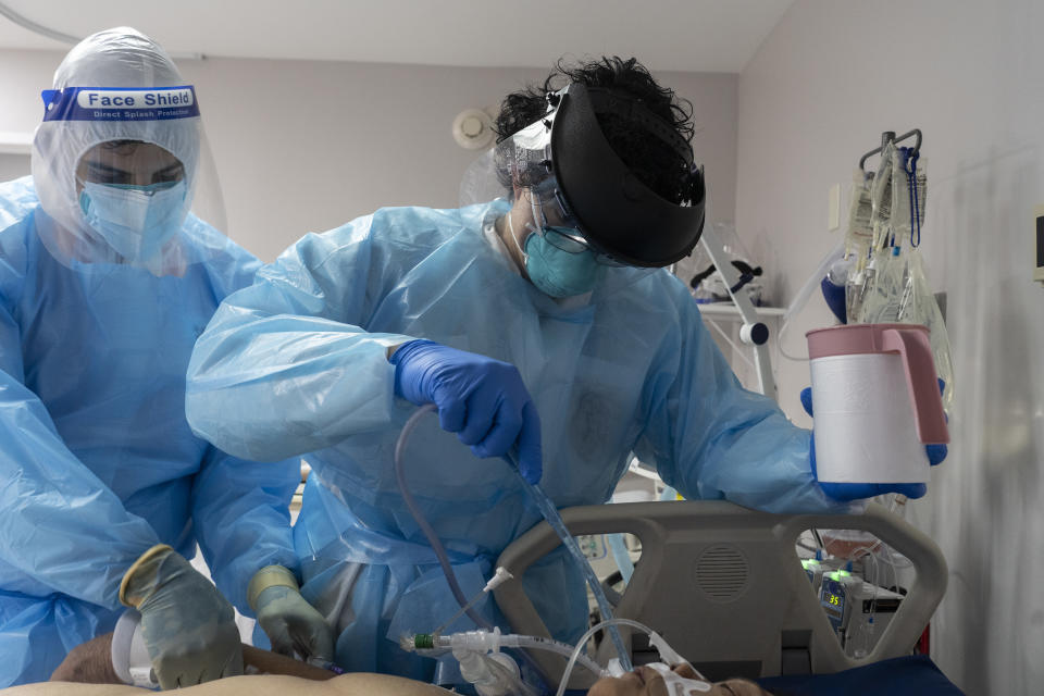 HOUSTON, TX - NOVEMBER 10: (EDITORIAL USE ONLY) Medical staff members treat a patient suffering from coronavirus in the COVID-19 intensive care unit (ICU) at the United Memorial Medical Center (UMMC) on November 10, 2020 in Houston, Texas. According to reports, COVID-19 infections are on the rise in Houston, as the state of Texas has reached over 1,030,000 cases, including over 19,000 deaths.  (Photo by Go Nakamura/Getty Images)