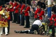 <p>A Royal Horse Guard is taken care of after being thrown from his horse. Even the band can't help but stare as they march by.</p>