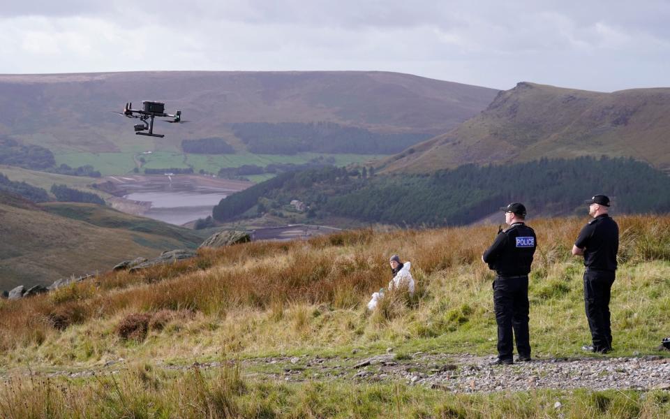 Police launch a drone for the search on Saddleworth Moor, in north west England - Danny Lawson/PA