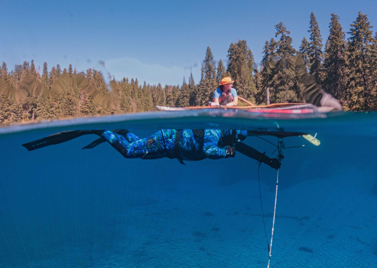 Under the watchful eye of wife Nikki Outzen, certified free diver Don Rathaus fills his lungs with air before descending 30 feet into the depths of Clear Lake.