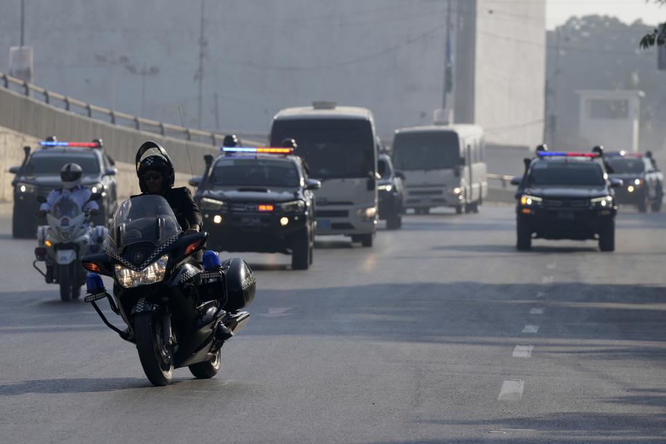 A special unit of national security forces escort a convoy of vehicles carrying New Zealand cricket team arriving to attend training session in the National Stadium, in Karachi, Pakistan, Friday, Dec. 23, 2022. (AP Photo/Fareed Khan)