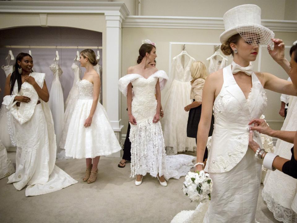 Models prepare for the 11th annual toilet paper wedding dress contest at Kleinfled's Bridal Boutique in New York June 17, 2015. The contestants competed in the annual Toilet Paper Wedding Dress Contest, showing off their dress-making skills using only Charmin toilet paper, glue, tape, Needle and thread, for the $10,000 cash prize. REUTERS/Brendan McDermid TPX IMAGES OF THE DAY