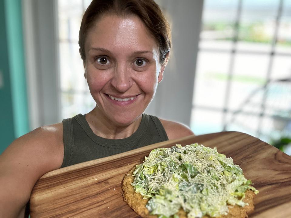 Author Terri Peters holding chicken crust pizza