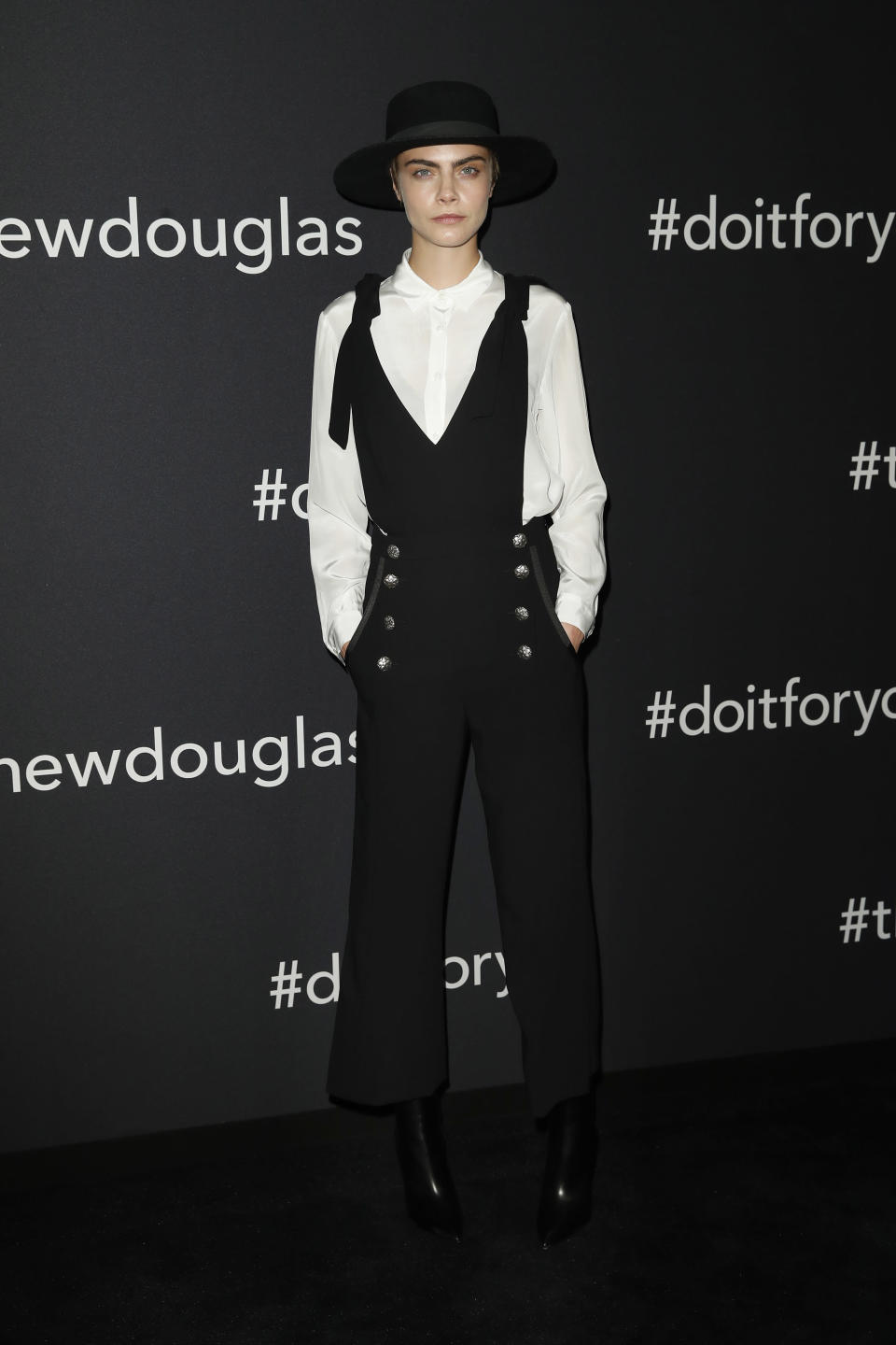 <p>On May 30, Cara Delevigne attended the Douglas X Peter Lindbergh campaign launch in Berlin wearing a black jumpsuit and co-ordinating hat. <em>[Photo: Getty]</em> </p>