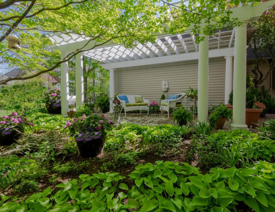 Donna and Dick Pfeil's garden is one of the seven gardens featured in the 2022 "Arts in Bloom Garden Walk" on June 29 in South Bend. Among other features, it includes this pergola and flagstone patio.