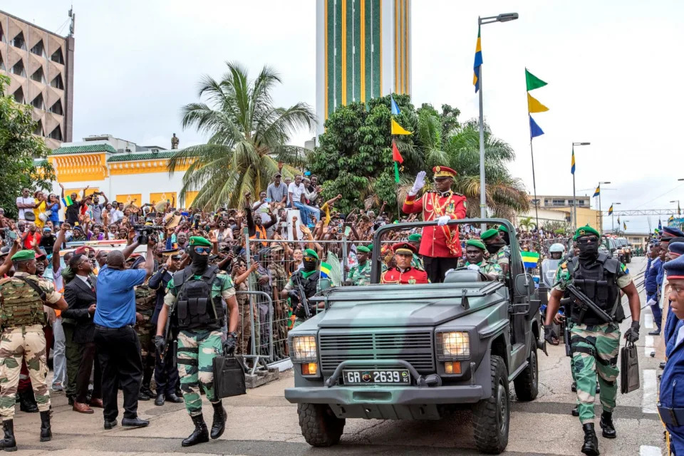 PHOTO: General Brice Clotaire Oligui Nguema greets the people of Gabon who came to cheer him after his inauguration as President of the Transition in Gabon, on Aug. 4, 2023 at the Presidential Palace in Libreville. (Desirey Minkoh/Afrikimages Agency/Universal Images Group via Getty Images)