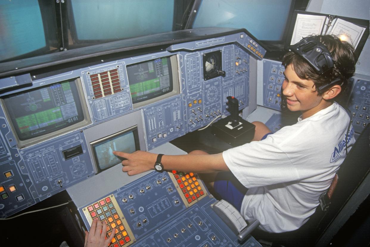 child at educational simulated Space Shuttle cockpit at Space Camp