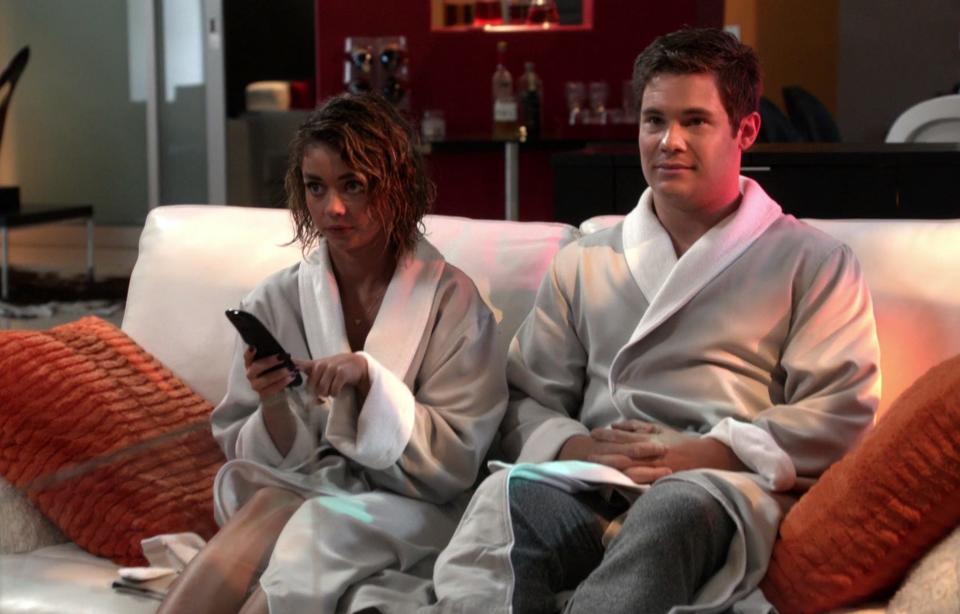 Haley and Andy sit on the couch wearing robes and try to turn off the romantic mood lighting