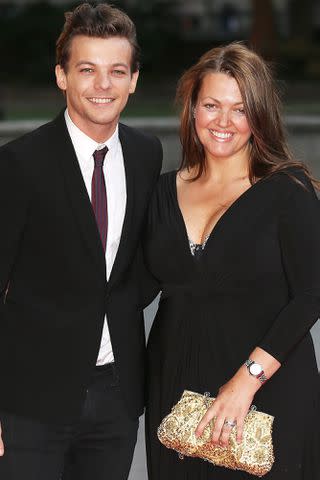 <p>Dave J Hogan/Getty</p> Louis Tomlinson and his mother Johannah Deakin (née Poulston) at the Natural History Museum in August 2015 in London.