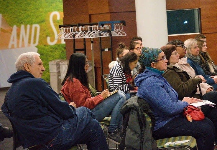 Martin Gugino, left, listens at a talk by West Cosgrove, of Rural & Migrant Ministry in Feb. 2019.