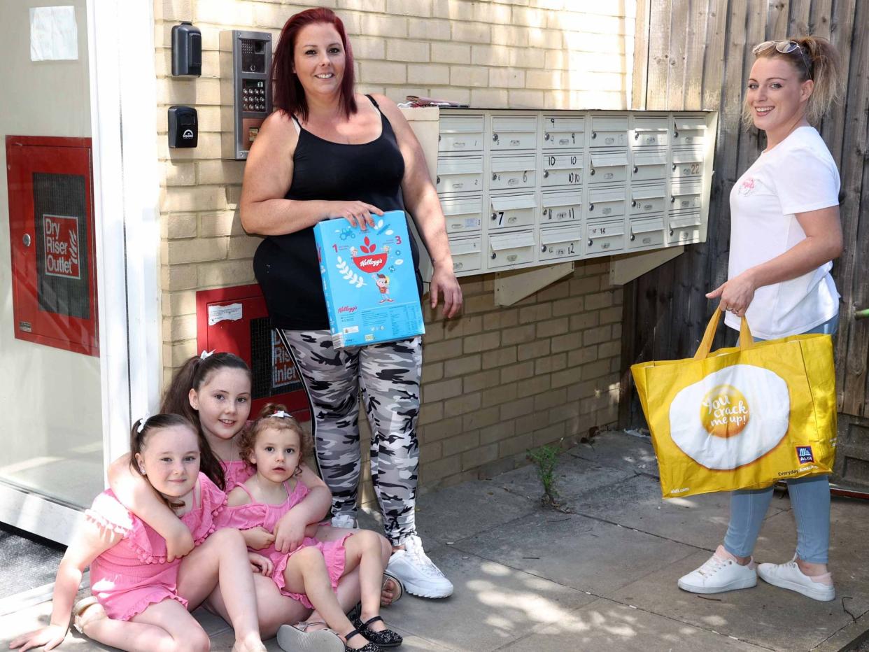 Becca Archer with her three daughters, given food donation by volunteer Katie-Louise Barber: Nigel Howard