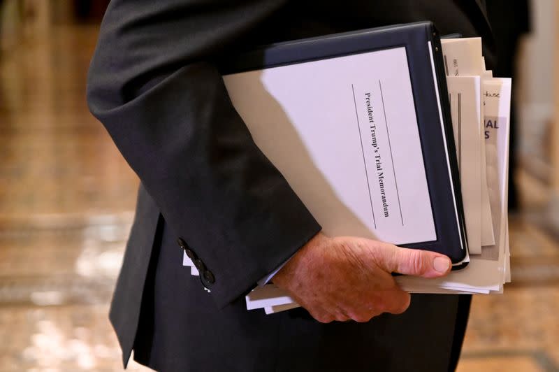 Sen. Leahy carries paperwork as he exits the Senate chamber after the third day of the Senate impeachment trial of President Trump