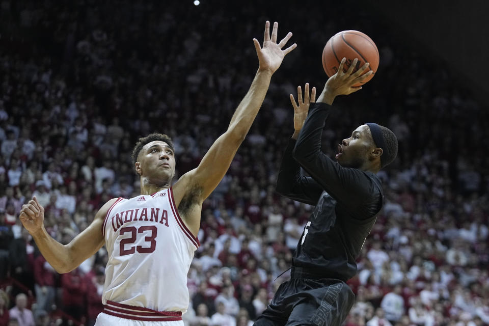 Michigan State's Tre Holloman (5) shoots over Indiana's Trayce Jackson-Davis (23) during the first half of an NCAA college basketball game, Sunday, Jan. 22, 2023, in Bloomington, Ind. (AP Photo/Darron Cummings)