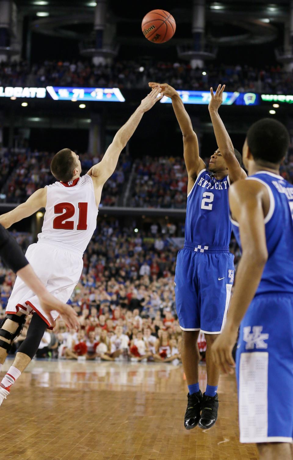In this April 5, 2014, file photo, Kentucky guard Aaron Harrison (2) makes a 3-pointer in the final seconds over Wisconsin guard Josh Gasser (21).