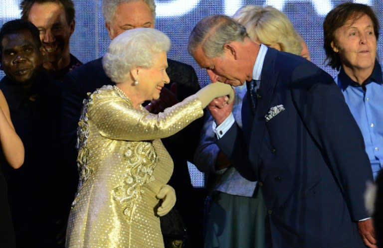 Prince Charles kisses the hand of his mother Queen Elizabeth II at a Jubilee concert at Buckingham Palace in London on June 4, 2012