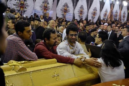 Relatives of victims react next to coffins arriving to the Coptic church that was bombed on Sunday in Tanta, Egypt, April 9, 2017. REUTERS/Mohamed Abd El Ghany