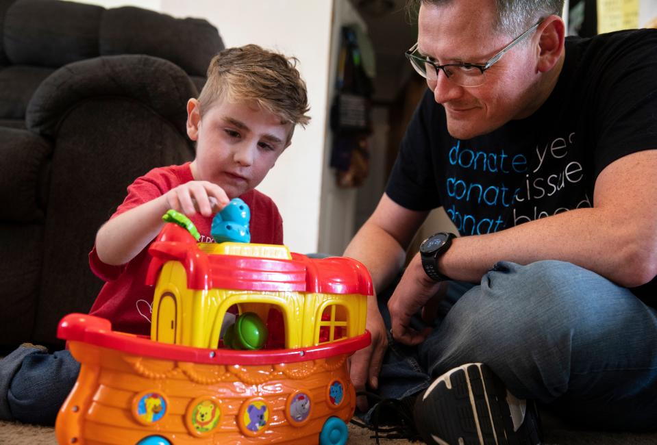 Eric Baker, of Independence, Kentucky, plays with his son James, 4. James, a heart transplant recipient at Cincinnati Children's Hospital Medical Center, wasn't a part of a study that focused on bedside huddles in the cardiac ICU but received the same treatment as kids in the study, preventing an impending cardiac arrest.