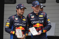 Sprint race winner Red Bull driver Max Verstappen, right, of the Netherlands stands with teammate and third placed Sergio Perez of Mexico at the Chinese Formula One Grand Prix at the Shanghai International Circuit, Shanghai, China, Saturday, April 20, 2024. (AP Photo/Andy Wong)