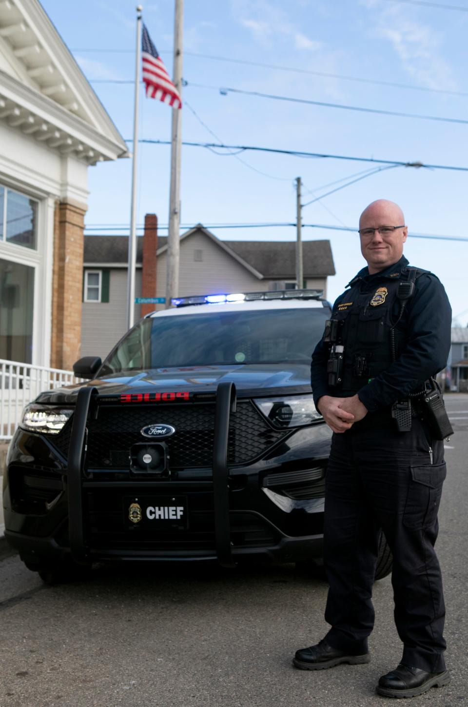 Chief of the Pleasantville Police Department Nick Garver as he stands next to one the Pleasantville police cruisers on Feb. 14, 2024, in Pleasantville, Ohio.