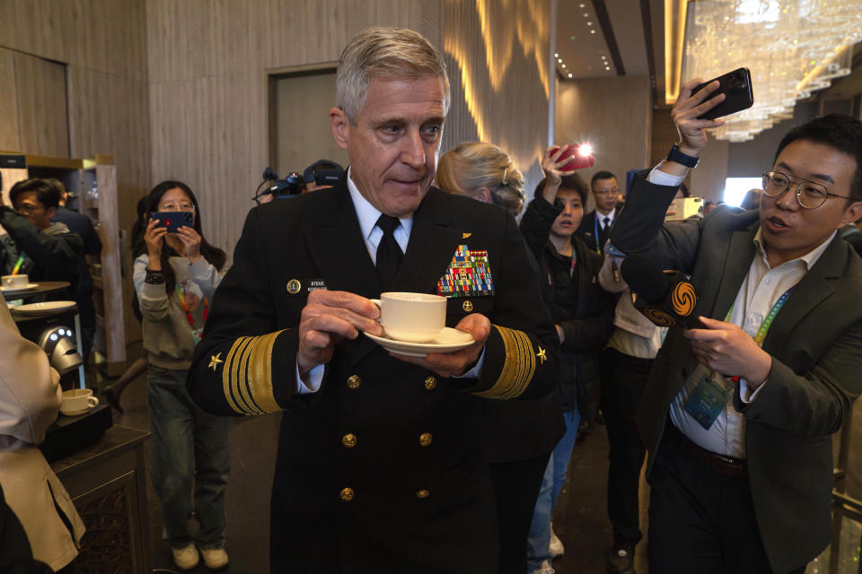 Steve Koehler, commander of the U.S. Pacific Fleet, center, tries to take a coffee break as journalists follow him during a break at the Western Pacific Navy Symposium in Qingdao in eastern China's Shandong province on Monday, April 22, 2024. The meeting has drawn representatives from partners and competitors including Australia, Cambodia, Chile, France, India and the U.S. and comes amid heightened tensions over China's assertive actions in the Taiwan Strait and the East and South China seas, and as China's navy has grown into the world's largest by number of hulls. (AP Photo/Ng Han Guan)