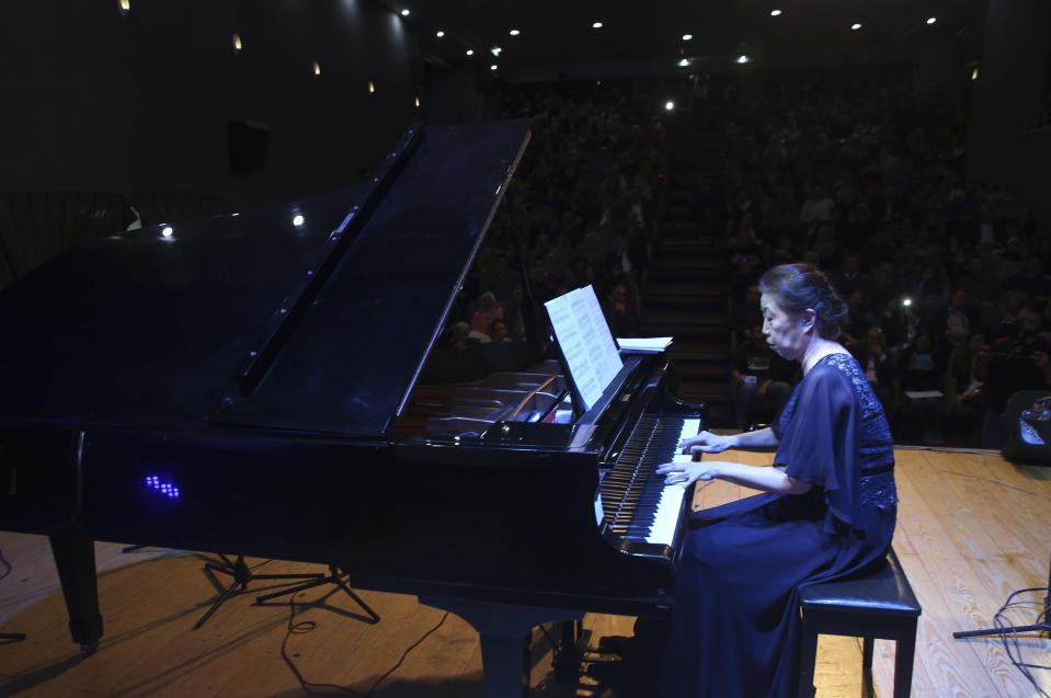 Japanese pianist Kaoru Imahigashi plays the piano during a concert to mark the debut of Gaza's only grand piano after it was rescued from conflict, at a theater nestled in the Palestinian Red Crescent Society's building in Gaza City, Sunday, Nov. 25, 2018. The only grand piano in the Gaza Strip is debuting to the public for the first time in over a decade after its restoration. (AP Photo/Adel Hana)