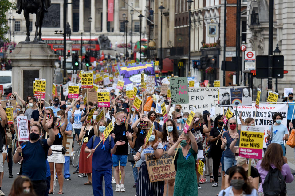 LONDON, UNITED KINGDOM - AUGUST 08: Nurses and other frontline NHS workers stage a protest at No 10 Downing Street after being left out of a public sector pay rise on August 08, 2020 in London, United Kingdom. NHS staff across the UK are demanding an early salary increase after they were not included in the governmentâs above-inflation coronavirus pay rise for public sector workers because of a three-year pay deal negotiated in 2018. (Photo by Kate Green/Anadolu Agency via Getty Images)