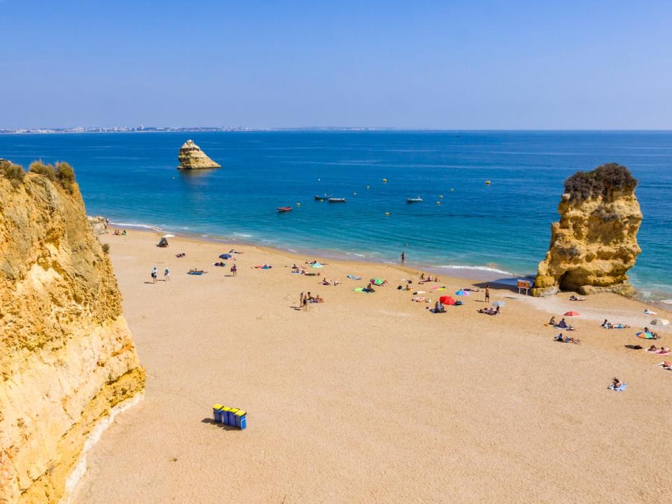 Climb down some steps onto this long, sandy beach with turquiose waters (Getty Images)