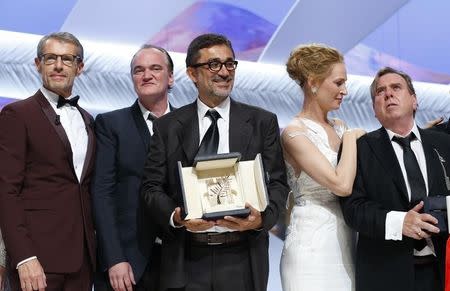(L-R) Master of Ceremony actor Lambert Wilson, director Quentin Tarantino, director Nuri Bilge Ceylan, Palme d'Or award winner for his film "Winter Sleep", actress Uma Thurman, and actor Timothy Spall, Best Actor award winner for his role in the film "Mr. Turner", pose on stage during the closing ceremony of the 67th Cannes Film Festival in Cannes May 24, 2014. REUTERS/Yves Herman