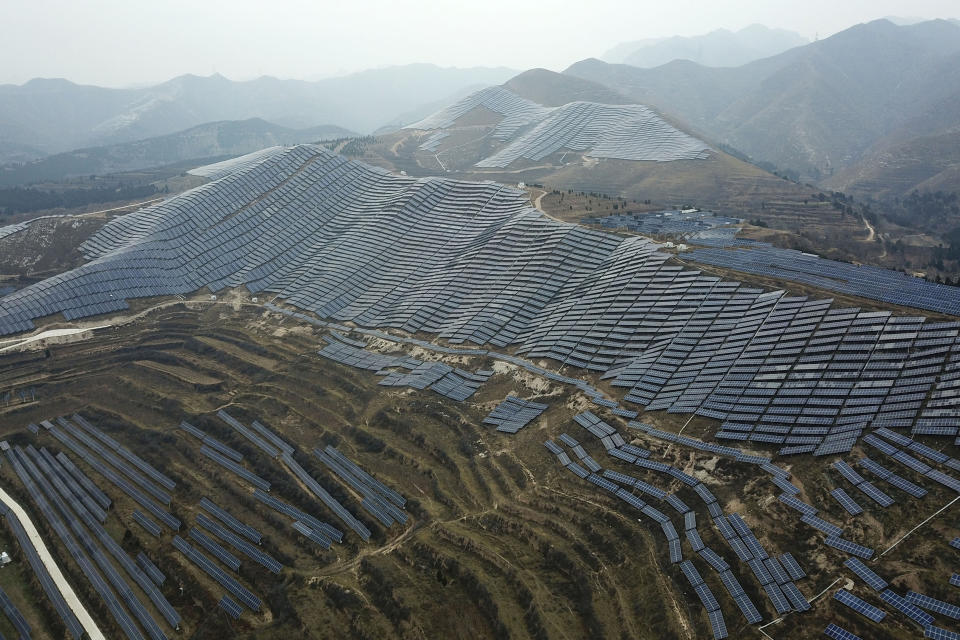 In this Nov. 27, 2019, photo, a solar panel installation is seen in Ruicheng County in central China's Shanxi Province. As world leaders gather in Madrid to discuss how to slow the warming of the planet, a spotlight is falling on China, the top emitter of greenhouse gases. China burns about half the coal used globally each year. Yet it's also the leading market for solar panels, wind turbines and electric vehicles. (AP Photo/Sam McNeil)