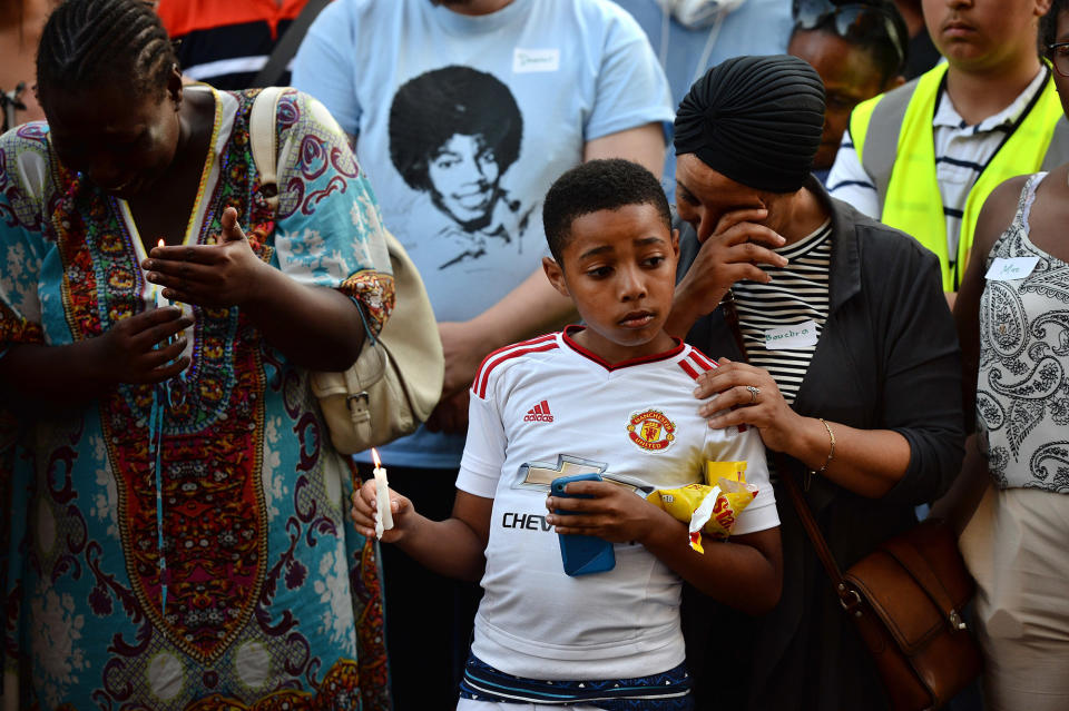 <p>Emotions run high as people attend a candle lit vigil outside Notting Hill Methodist Church near the 24 storey residential Grenfell Tower block in Latimer Road, West London on June 14, 2017 in London, England. (Photo: Chris J Ratcliffe/Getty Images) </p>