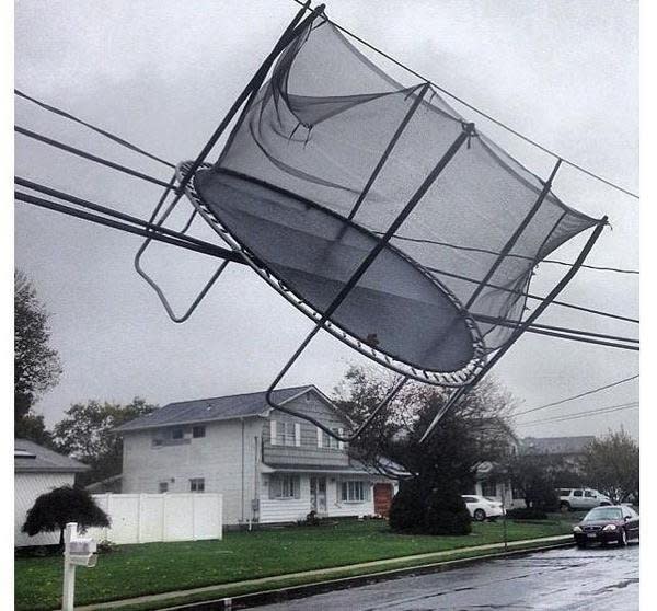 Click the photo to go to a slideshow of reader photos of Sandy. Here, the superstorm entangled a trampoline in Connecticut power lines. (Photo credit: Derek Oxley)