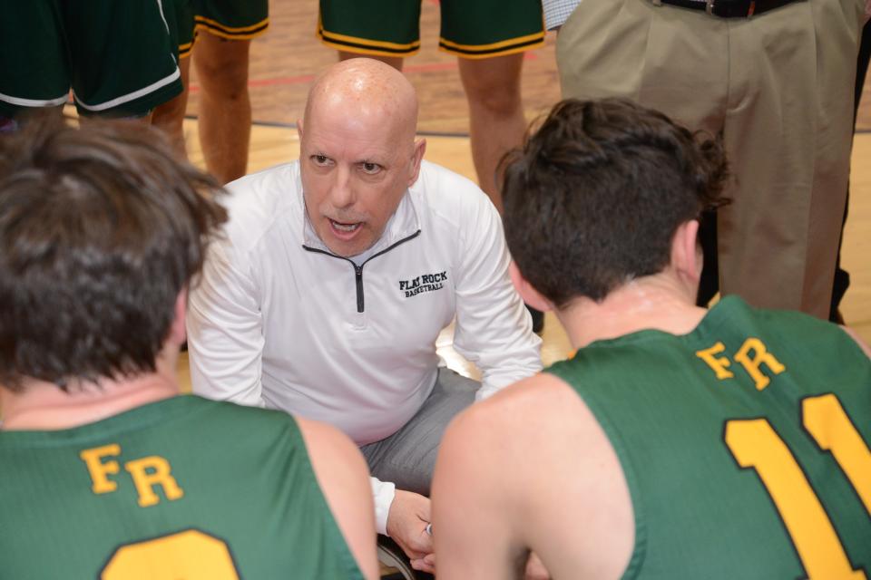 Flat Rock boys basketball coach Rick Smith talks to his team during the semifinals of the Division 2 District at New Boston Huron Wednesday.